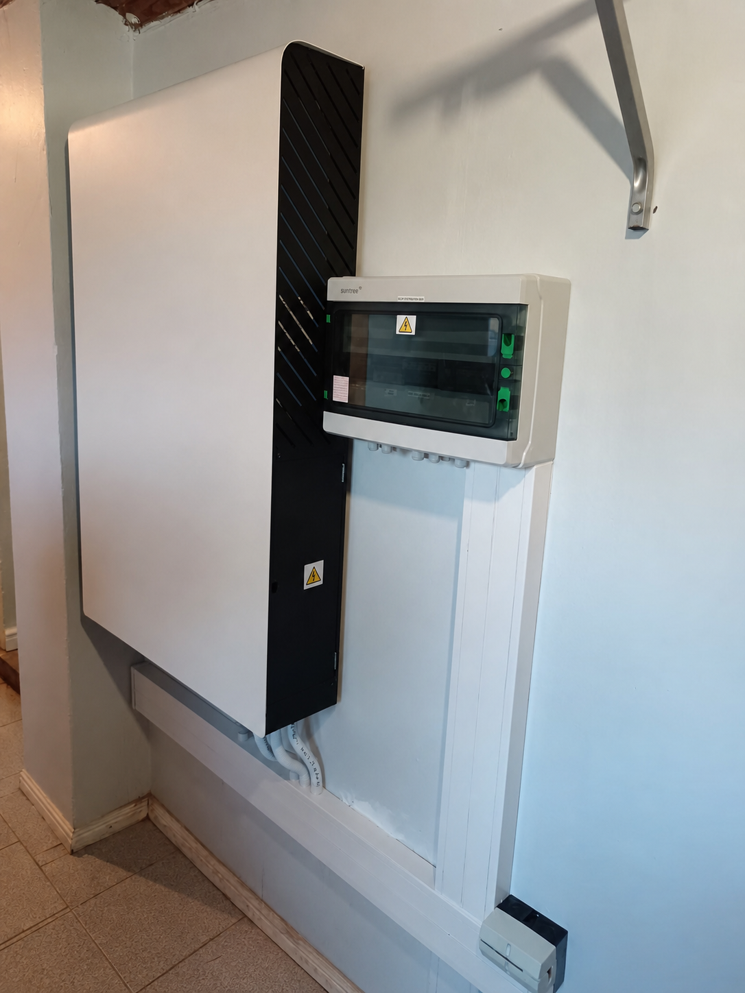 Indoor solar inverter installation with enclosed wiring and distribution board